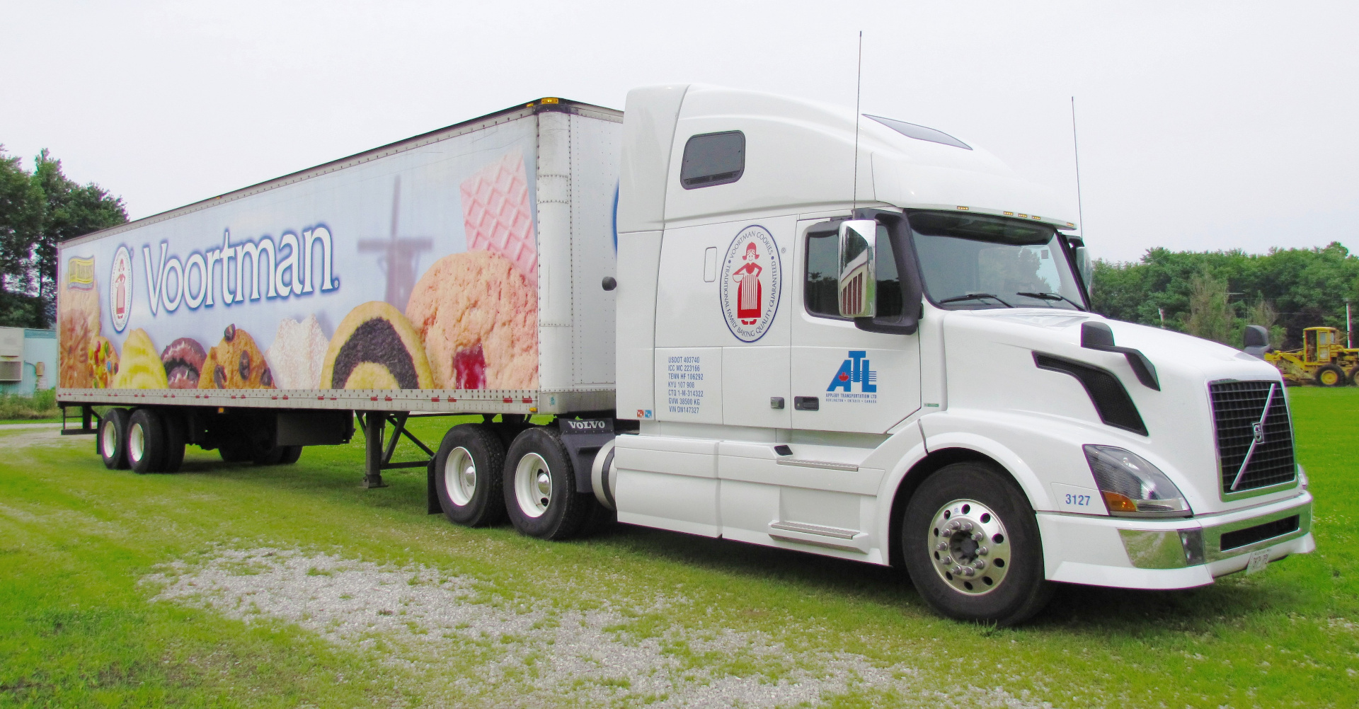 A white Volvo semi-truck with a Voortman Cookies trailer — the kind of rig that carried me across North America.